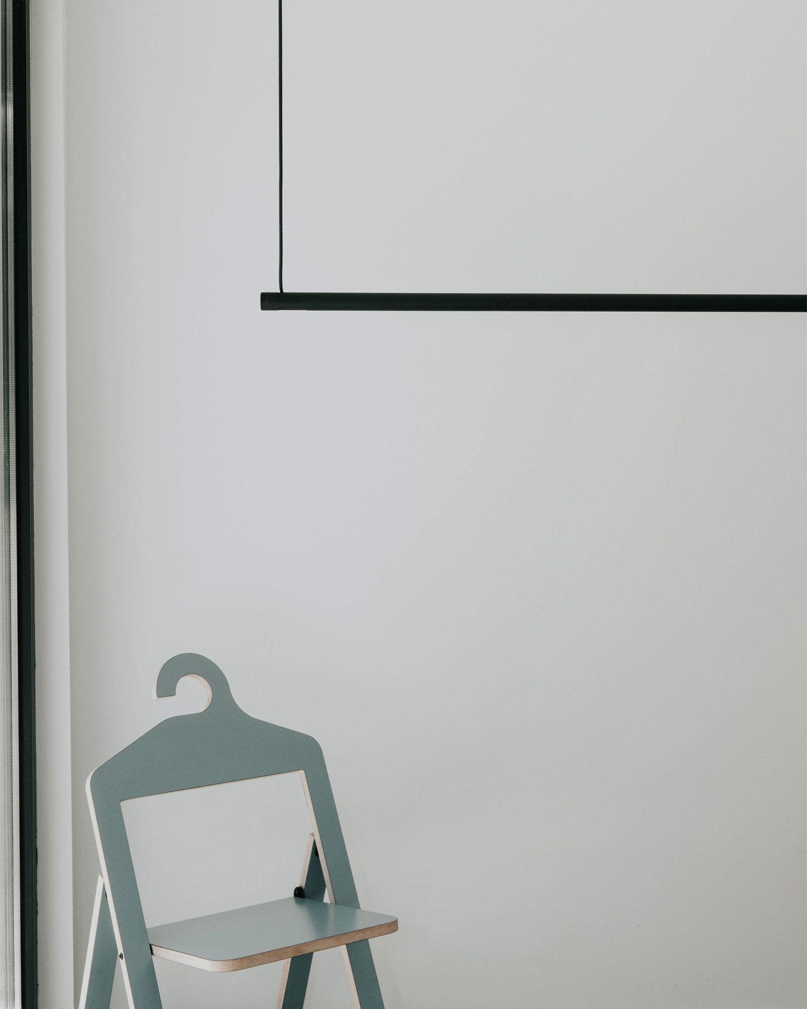A hanging clothing rack in a modern bedroom