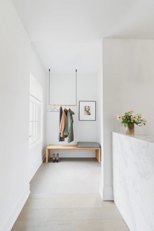 Woman hanging coats on a clothing rack